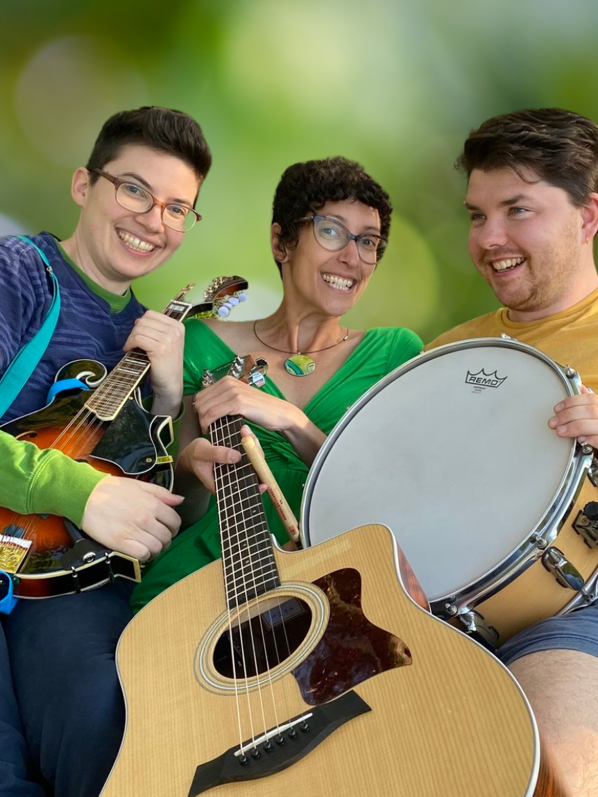 Three young, smiling musicians with short, dark hair hold string and percussion instruments.