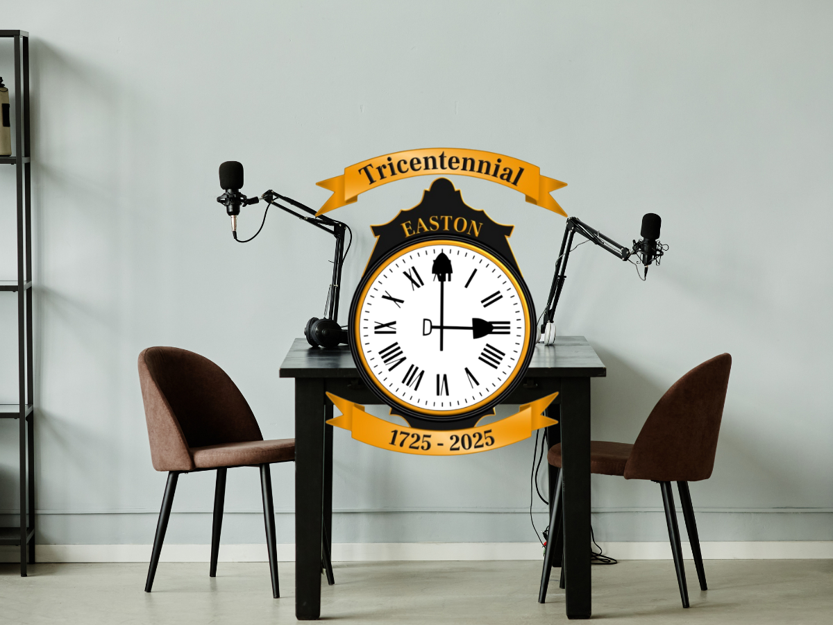 Table with a chair and microphone on either side. Easton's Tricentennial logo sits in the foreground of the image.