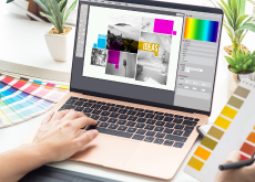 laptop showing graphic design on screen
