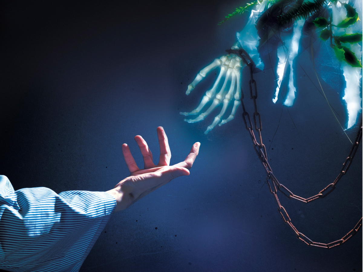 Scrooge's hand reaching for ghostly hand