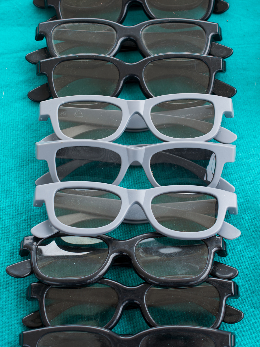black and gray sunglasses on a blue cloth background