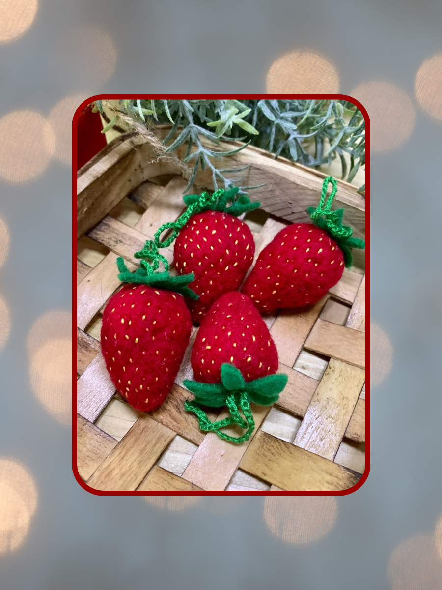 twinkling background with felted strawberries in basket in foreground