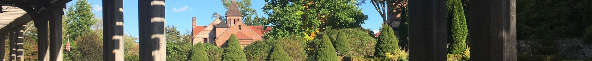 peak of Ames Free Library as seen through the trees from Queset Garden
